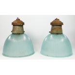 A pair of mid 20th century holophane prismatic glass pendant ceiling lights with metal galleries. (
