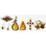 A silver and amber flowerhead cluster ring and five other silver and amber set pieces.