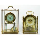 A brass anniversary clock by Kundo, with graduated grey dial, under a glass case, with swing