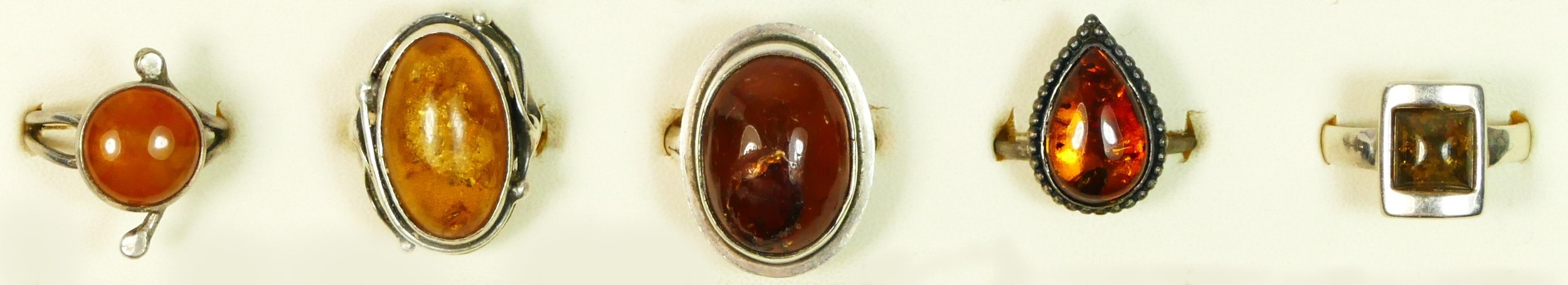 Five silver and amber set rings, 24gm