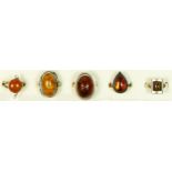 Five silver and amber set rings, 24gm