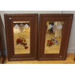 A pair of Victorian wall mirrors, painted with flowers, with oak frames and bevel edge glass.