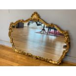 A modern giltwood overmantle mirror, with sophisticated scroll work. 120x90cm.