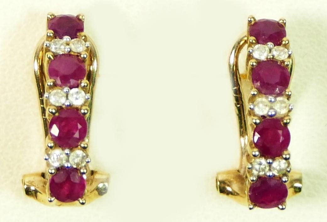 A pair of 9ct gold ruby and brilliant cut diamond ear studs, 16 x 4mm, 2.8gm