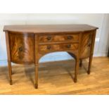 An Edwardian mahogany sideboard, having shaped inlaid top above two central frieze drawers flanked