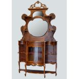 A Victorian mahogany ornate display cabinet, the shaped raised back set with a bevelled oval