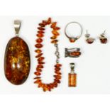 A large 925 silver and amber pendant, 55 x 31mm, and five other anmber set jewellery pieces.