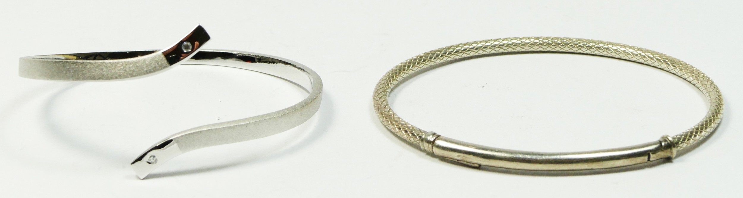 Chamilia, a silver snake skin bangle and a a 925 silver twist bangle, 28gm