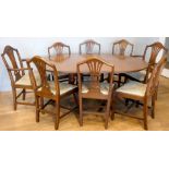 A late 20th century mahogany extending dining table, twin pedestal with single leaf, together with a