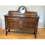 An Edwardian oak mirror back sideboard, raised back incorporating central bevel edge mirror, over