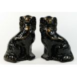 A pair of English Staffordshire pottery King-Charles spaniel dogs, circa 1890s, glazed black with