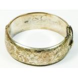 A silver hinged bracelet, Birmingham 1960, with engraved front, 21mm wide, 36.8gm, case. To be