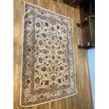 A Buckingham range wool rug retailed by Gooch Oriental Carpets, hand tufted, with brown and beige