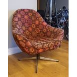 A 1970s French swivel armchair, with original floral fabric upholstery, raised on four chrome