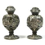 Two 19th century silver pepper castors, apparently unmarked, 7cm, 87gm