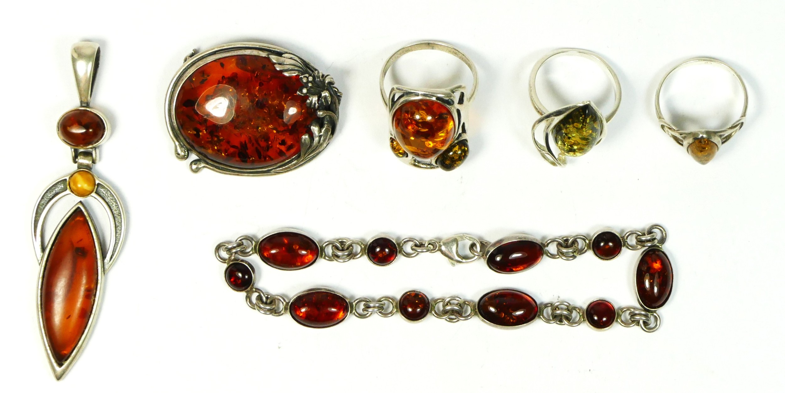 A silver and amber set bracelet and five other amber set pieces, 41gm