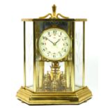 A Kundo of Germany brass cased hexagonal anniversary clock, the circular enamelled dial with