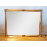 A substantial gilt framed wall mirror, having bevel edge glass, 136x106cm.