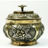 An Eastern silver lidded jar with embossed and chased decoration, diameter 6.5cm, 90gm