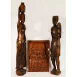 Two ebony carvings of an African man & woman, 93cm tall, together with a carved plaque 29x43cm. (3)