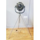 A 1950s electric theatre floor lamp, raised on an adjustable tripod stand. (re-wired)