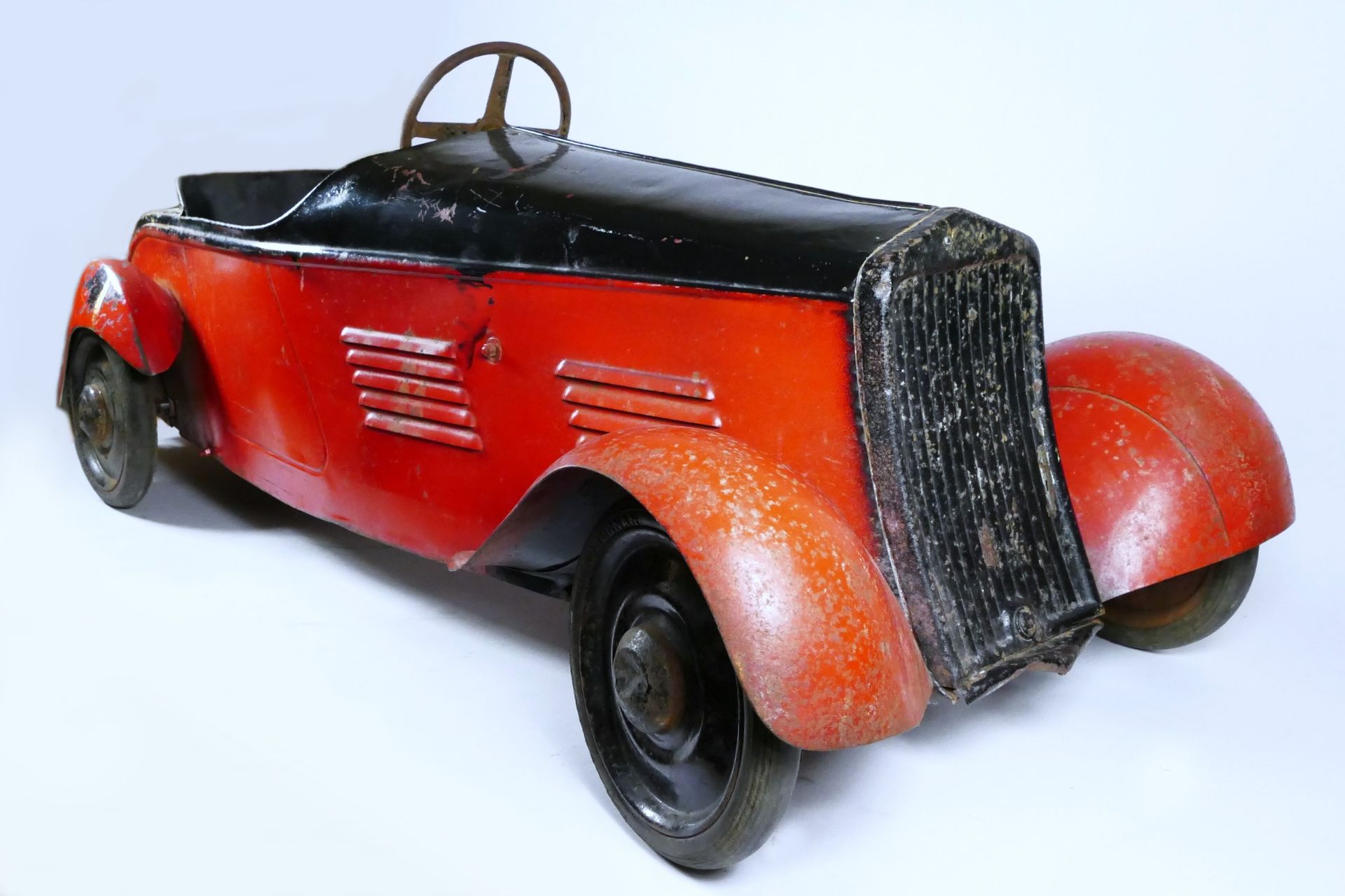 Eureka Super Junior 35 child's pedal car, c.1935-38, metal body painted in red over black, metal