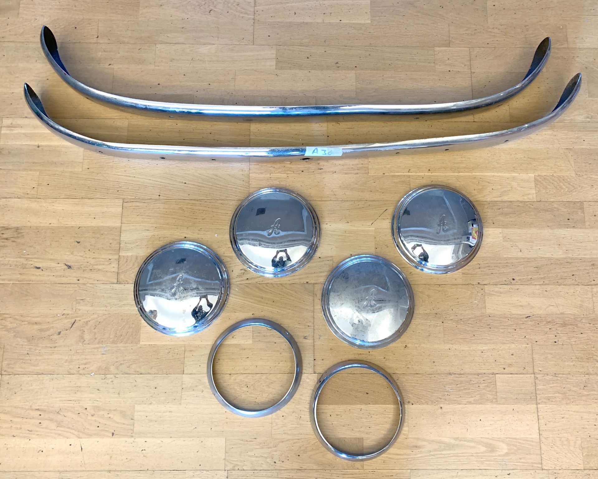 A selection of Austin A30 chromed trim, to include bumpers, hubcaps and headlight surrounds.