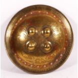 Indo-Persian brass silver inlaid and red enamelled circular shield, with four central bosses and