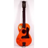 A New Beat guitar, four strings, plastic neck and body, decorated with New Beat logo, Beatles