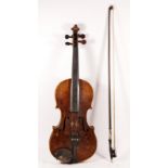 A violin, labelled internally "Copy Of Antonius Stradivarius", with cheek piece , together with a