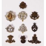 A collection of ten cap badges to include Royal Electrical and Mechanical Engineers, The Royal Scots