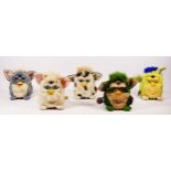 Five Furby toys, made by Tiger, one with original tag and purple seal, one with original tag, one