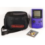 A Nintendo Game Boy Color, in purple/grape colourway, model No CGB-001 (serial No CG100008852),