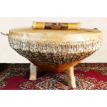 A animal hide drum table, possibly African in origin, animal skin drum head with raw hide bracing,