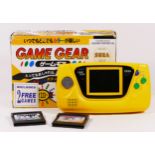 A Sega Game Gear hand held console (serial No P61054129), Japanese limited edition, yellow, together