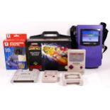 A collection of Nintendo Game Boy and SNES related handhelds and accessories, two Super Game Boy