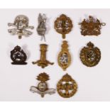 A collection of ten cap badges to include The Royal Dublin Fusiliers, Royal Engineers and The