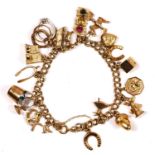 A 9ct gold curb link bracelet, with multiple charms, including a church and a traffic light, 32.4gm