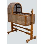 A Victorian mahogany and cane work cradle, of traditional form, raised on turned supports. L94,
