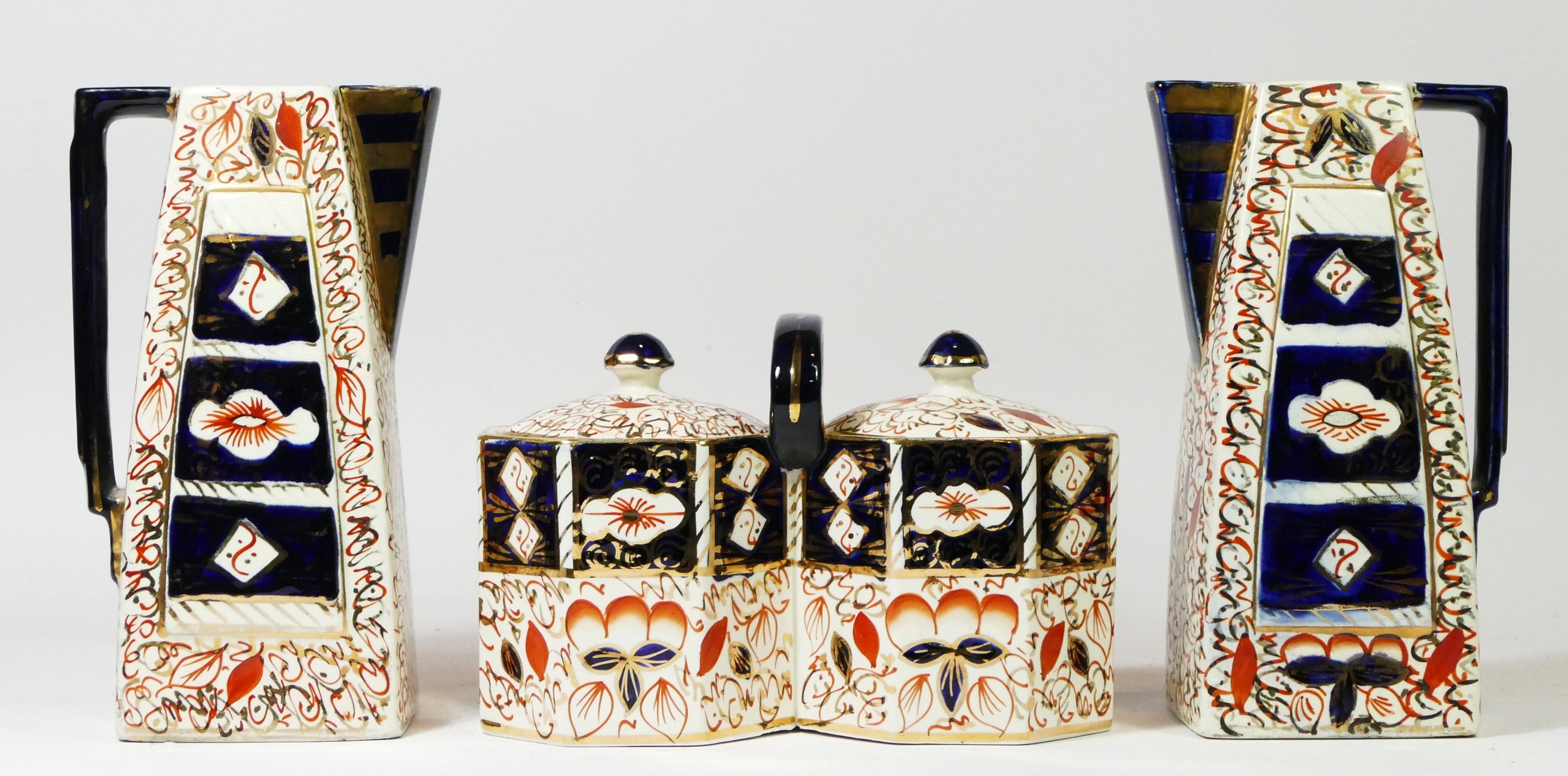 A pair of late 19th century Imari pattern English Wadeheath pitchers, 22cm tall, together with a