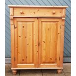 A stripped pine tallboy, comprising of single frieze drawer over twin cupboards. H136, W105, D50cm.
