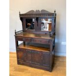 An Early primitive oak court cupboard, having galleried mirror backed shaped panel, over two