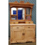 A stripped pine kitchen dresser, with moulded cornice above a three tier plate rack, with frieze