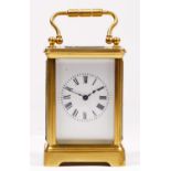 A small brass carriage time piece, white enamel dial, 8.5cm, key, balance spins but not working