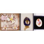 Royal Crown Derby porcelain, an orchid brooch and ear clip suite, brooch 5.0 x 4.5cm, case, together