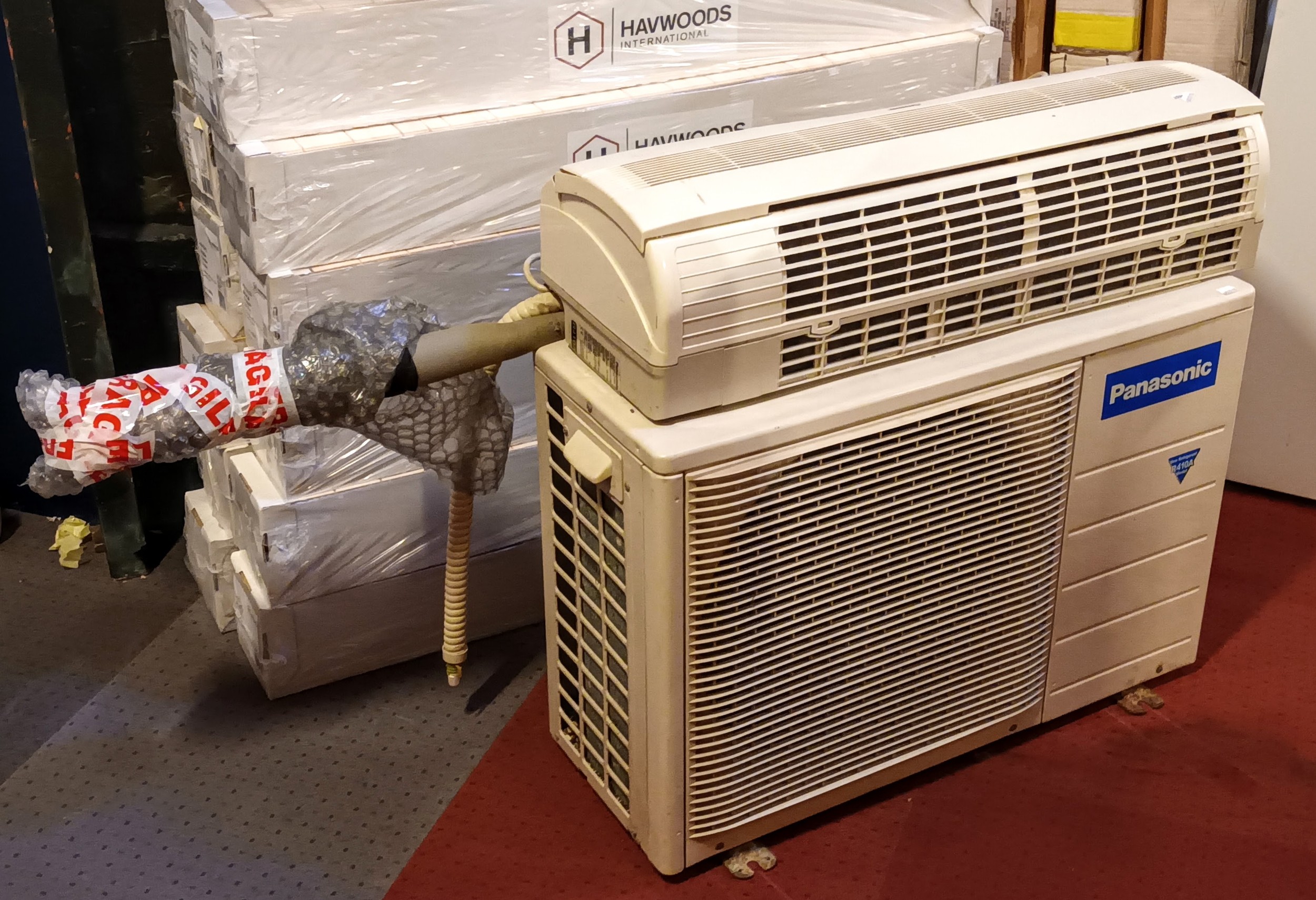 A Panasonic air conditioning unit R410A, untested, 80cm x 54cm x 30cm, together with a Panasonic Ion