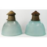 A pair of mid 20th century holophane prismatic glass pendant ceiling lights, with metal