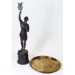 A bronzed spelter figure of a young Russian man stood proud holding a Hammer & Sickle flag aloft,