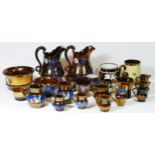 A collection of early 20th century and later copper lustre pottery wares, to include graduated jugs,