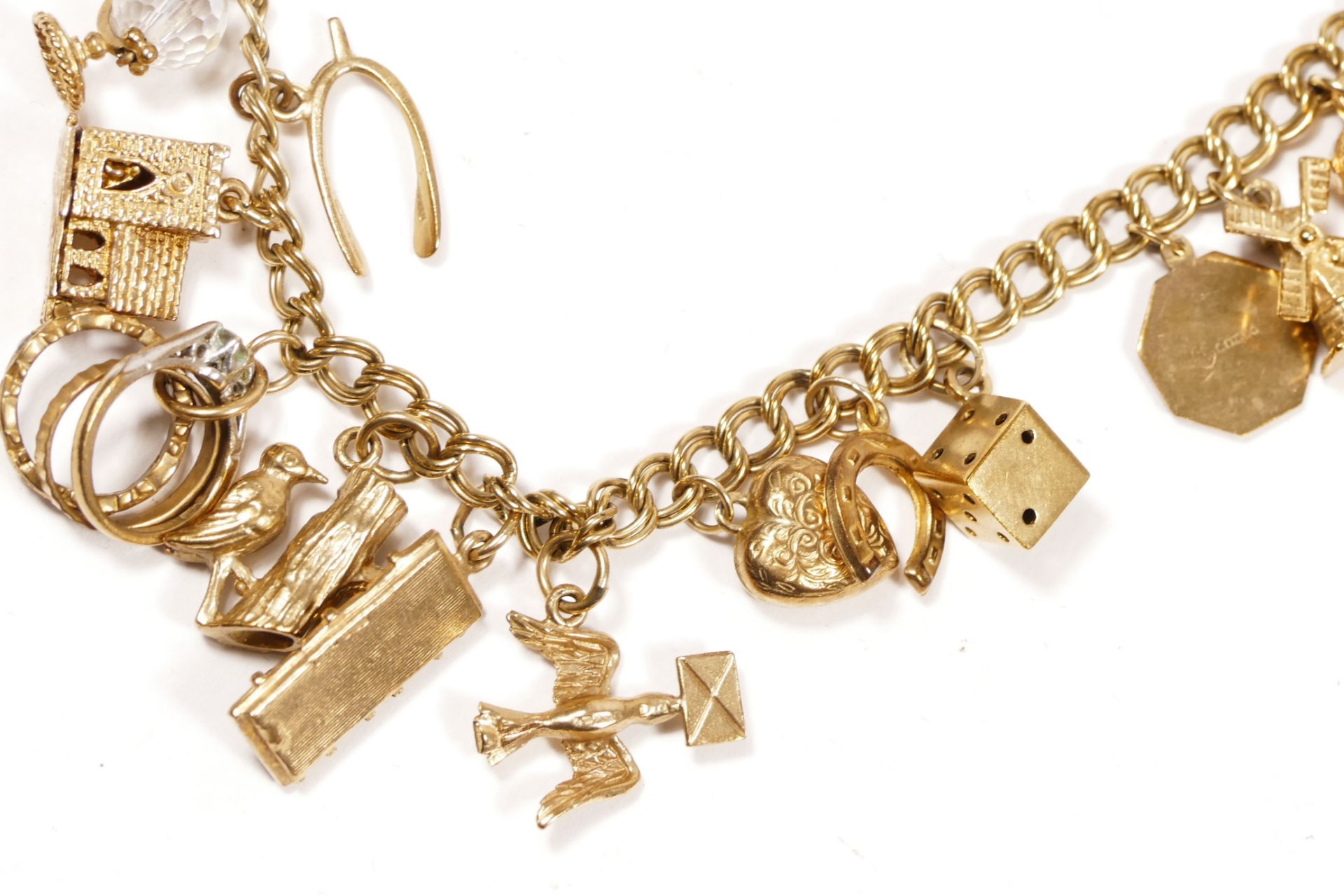 A 9ct gold curb link bracelet, with multiple charms, including a church and a traffic light, 32.4gm - Image 5 of 6